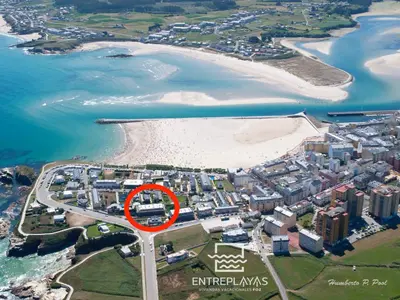 an aerial view of a beach with a red circle at Viviendas Vacacionales ENTREPLAYAS. Foz. in Foz