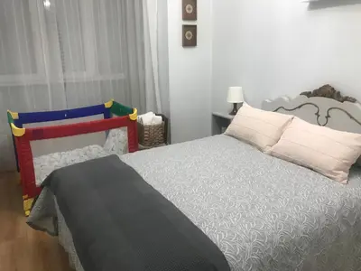 a bedroom with a large bed with white pillows at El 0tro Cuartín in Ponferrada