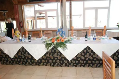 a table with a white table cloth with flowers on it at Complejo Hostelero Paladium in Villamartín
