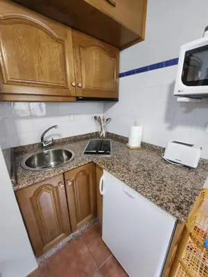 a kitchen with a table and a dining room at Valles del Narcea, Apartamentos Rurales in Cangas del Narcea