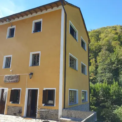 a mirror in front of a bedroom with a bed at Valles del Narcea, Apartamentos Rurales in Cangas del Narcea