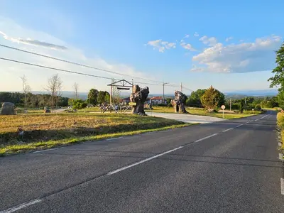 an empty road with statues of animals on the side of the road at Loft con Jacuzzi os Arcos in Sober