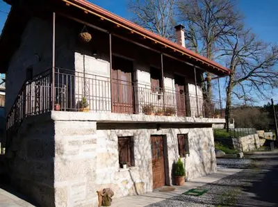 a building with a balcony on the side of it at CASA TIO HERMINIO in O Irixo