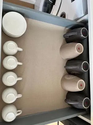 a drawer filled with white plates and cups at Oktheway Perbes Beach 2 in Boebre