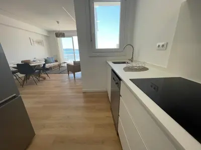 a kitchen with a counter and a dining room at Oktheway Perbes Beach 2 in Boebre