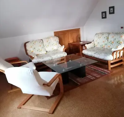 a living room with two couches and a glass table at Casa do Pombar en Valdeorras in Seadur