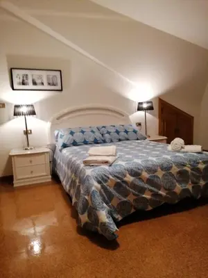 a bedroom with a bed and two night stands and two lamps at Casa do Pombar en Valdeorras in Seadur