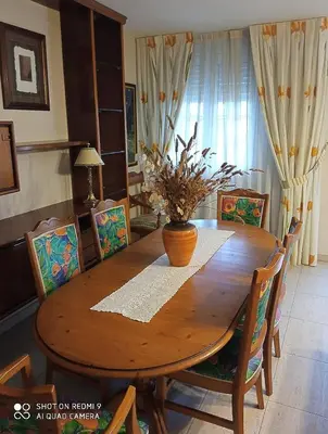 a dining room table with a vase on top of it at Casa do Pombar en Valdeorras in Seadur