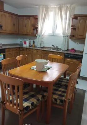 a kitchen with a wooden table with chairs and a bowl on it at Casa do Pombar en Valdeorras in Seadur