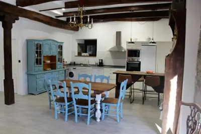 a kitchen with blue cabinets and a table and chairs at Casa Rural Estrella del Sil in Corbón del Sil