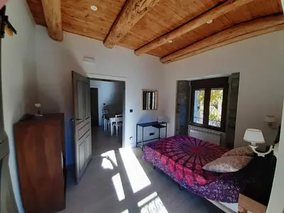 a bedroom with a bed and a table in a room at Casa Rural Estrella del Sil in Corbón del Sil