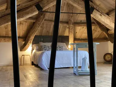a bedroom with a white bed and a table at Casa Rural Estrella del Sil in Corbón del Sil
