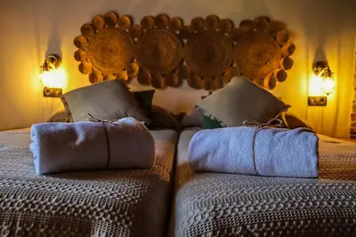a bedroom with two beds with pillows on them at Fogar de Lecer in Arzúa