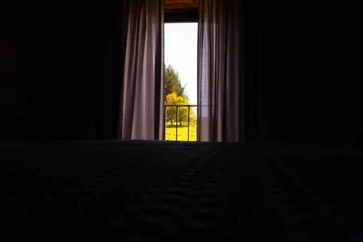 a bedroom with a window with a view of a yard at Fogar de Lecer in Arzúa