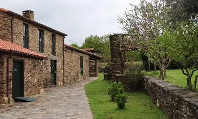 an alleyway leading to an old stone building at Fogar de Lecer in Arzúa