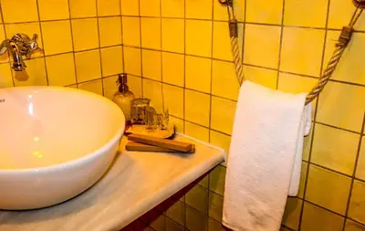 a bathroom with a white sink and a towel at Fogar de Lecer in Arzúa