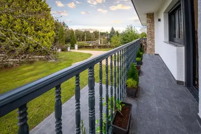 a balcony with a railing and a yard at Finca Bacelo Ribeira Sacra in Sober