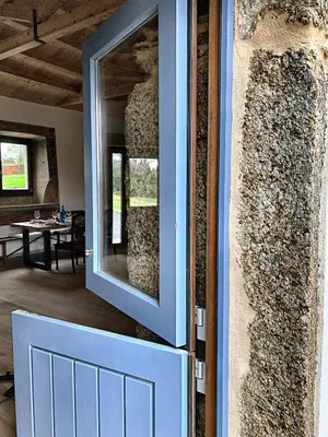 a door with a mirror on the side of a house at Rectoral de Boente in Arzúa