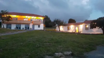 a house with lights on the outside of it at Rectoral de Boente in Arzúa