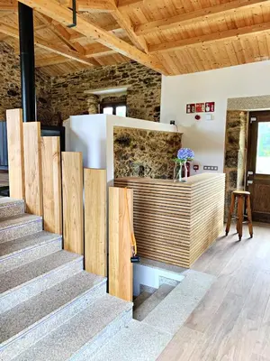 a staircase in a room with a stone wall at Rectoral de Boente in Arzúa