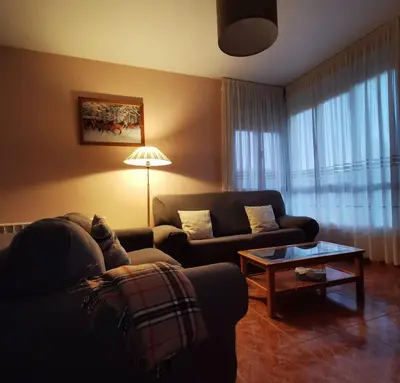 a living room with a couch and a table at Vista Estrelada in Requeixo