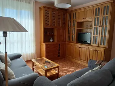 a living room with a blue couch and a tv at Vista Estrelada in Requeixo