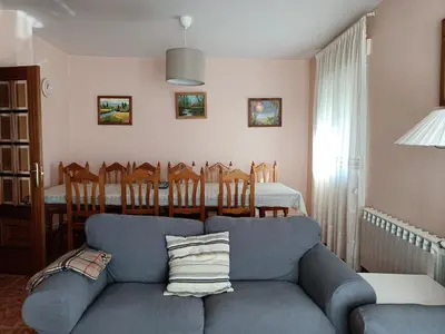 a living room with a blue couch and a table at Vista Estrelada in Requeixo