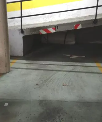 an empty parking lot with a caution sign on the ground at Piso Lomberte in Allariz