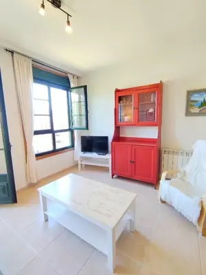 a living room with a red cabinet and a coffee table at Indiano 4B in Viveiro