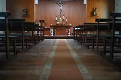 a church altar with a vase of flowers and a cross at A Casa da Toura in Puentedeume