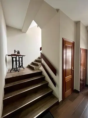a hallway with stairs and a table and a table at Piso en pleno centro de Miño derecha in Miño