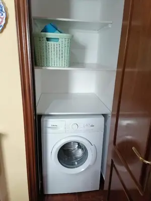 a white washer and dryer in a room at Piso en pleno centro de Miño derecha in Miño