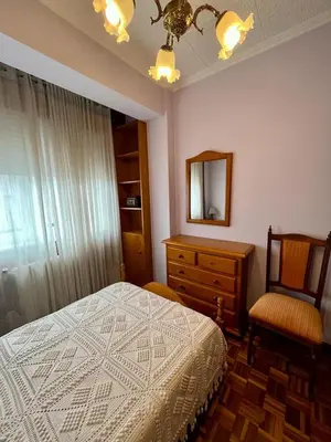 a bedroom with a bed and a dresser and a mirror at Piso en pleno centro de Miño derecha in Miño