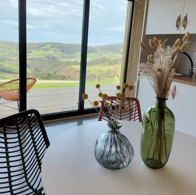 two vases sitting on a table with flowers in them at Cabañas Huma 1 in Villameitide