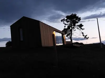 a small house with a window in a field at Cabañas Huma 1 in Villameitide