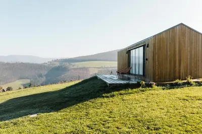 a wooden house sitting on top of a hill at Cabañas Huma 1 in Villameitide