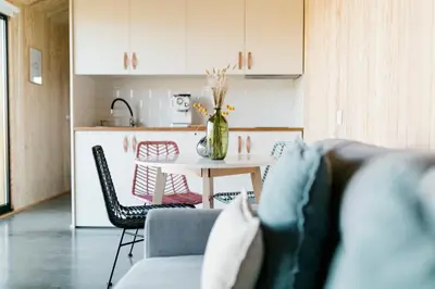 a living room with a table and a kitchen at Cabañas Huma 1 in Villameitide