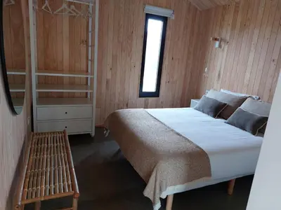 a bedroom with a large bed and a window at Cabañas Huma 1 in Villameitide