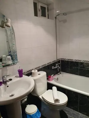 a bathroom with a toilet and a sink and a tub at Pension A Barca in O Barco de Valdeorras