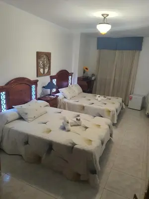 a group of four beds in a room at Pension A Barca in O Barco de Valdeorras