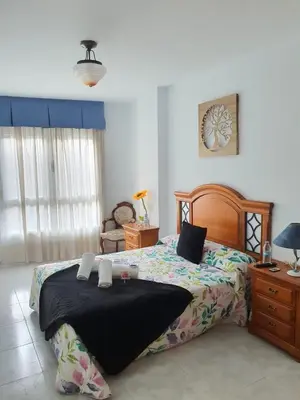 a bedroom with a large bed and a dresser at Pension A Barca in O Barco de Valdeorras