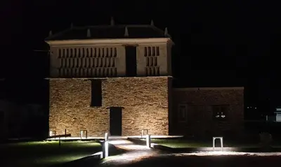 a large brick building with a tower at night at 