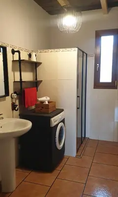 a bathroom with a washing machine and a sink at 