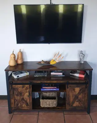 a wooden entertainment center with a flat screen tv on a wall at 