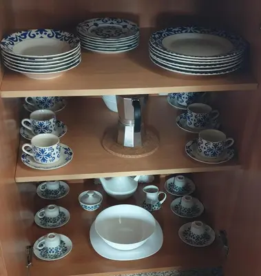 a cabinet filled with plates and cups and saucers at 