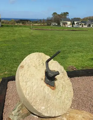 a statue of a iron object in a field at 