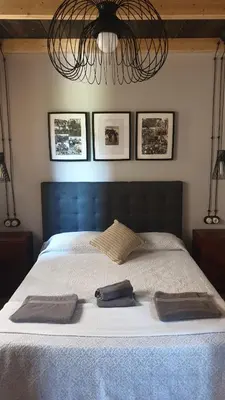 a bedroom with a bed with two towels on it at 