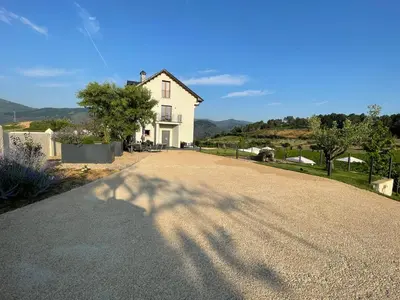 an empty road in front of a white house at Boutique Finca esencial Hotel Rural in Villafranca del Bierzo