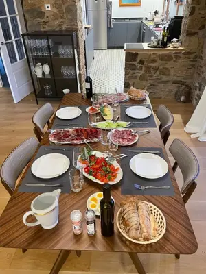 a wooden table with food on top of it at Boutique Finca esencial Hotel Rural in Villafranca del Bierzo