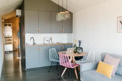 a kitchen and dining room with a table and chairs at Cabañas Huma 2 in Vegadeo